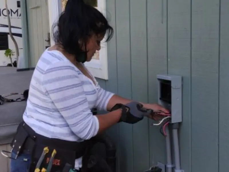 Licensed electrician wiring an exterior subpanel in St. Peter