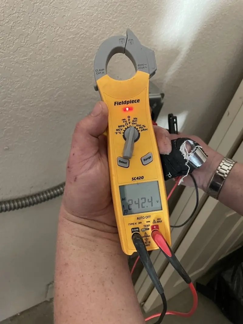 Voltage testing with clamp meter during Outlet Installation in St. Peter